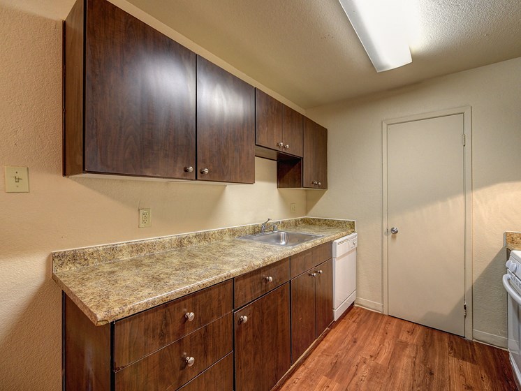 Kitchen with  Granite Quartz Counter Countertop, Refrigerator, Stove, Hardwood Inspired Wood Floor